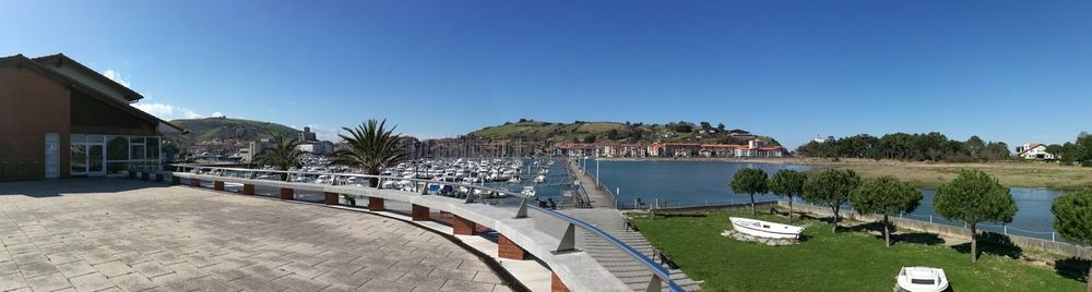 Panoramic view of swimming pool against clear blue sky