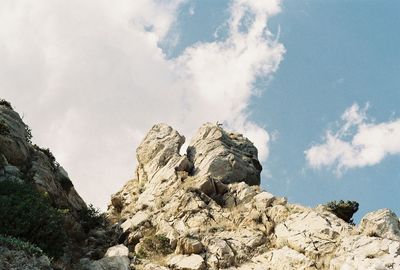 Low angle view of rock formation against sky