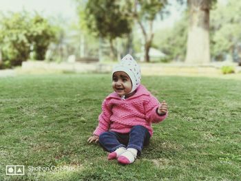 Full length of smiling boy on grass