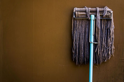 Close-up of mop against wall