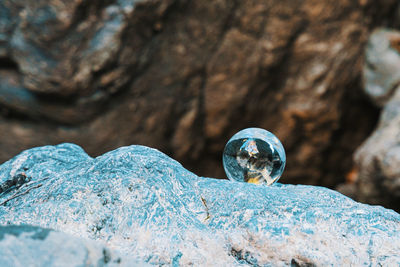 Close-up of crystal ball on rock