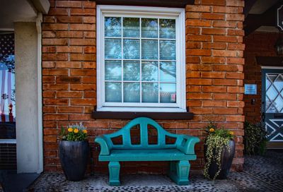 Potted plants on table by window of building