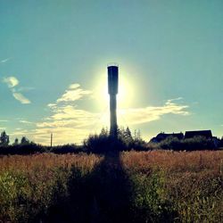 Smoke stack on field against sky