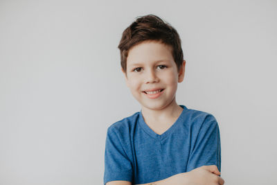 Portrait of boy against gray background