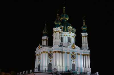 Low angle view of illuminated building against sky at night