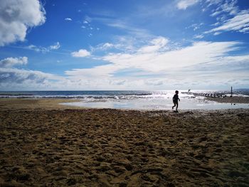 Man on beach against sky