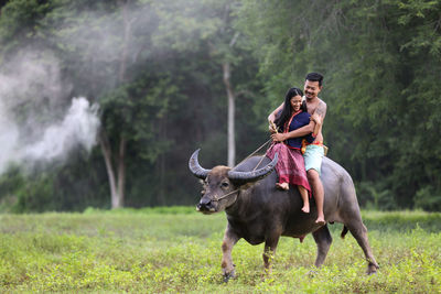 Man riding horse on field