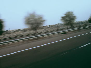 Blurred motion of road against clear sky