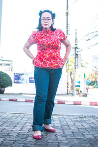 Portrait of young woman standing on street