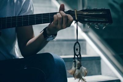 Cropped image of man holding guitar