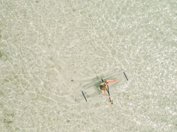 Directly above shot of woman on inflatable boat in sea