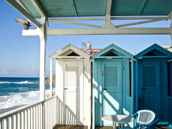 Built structure on beach by sea against sky