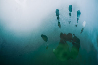 Image of hand marks caused by steam on the glass.