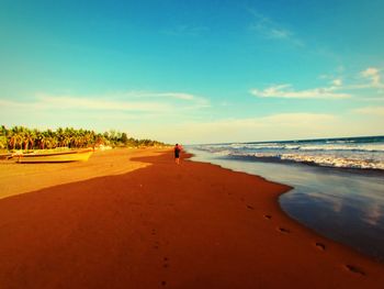 Scenic view of beach against blue sky