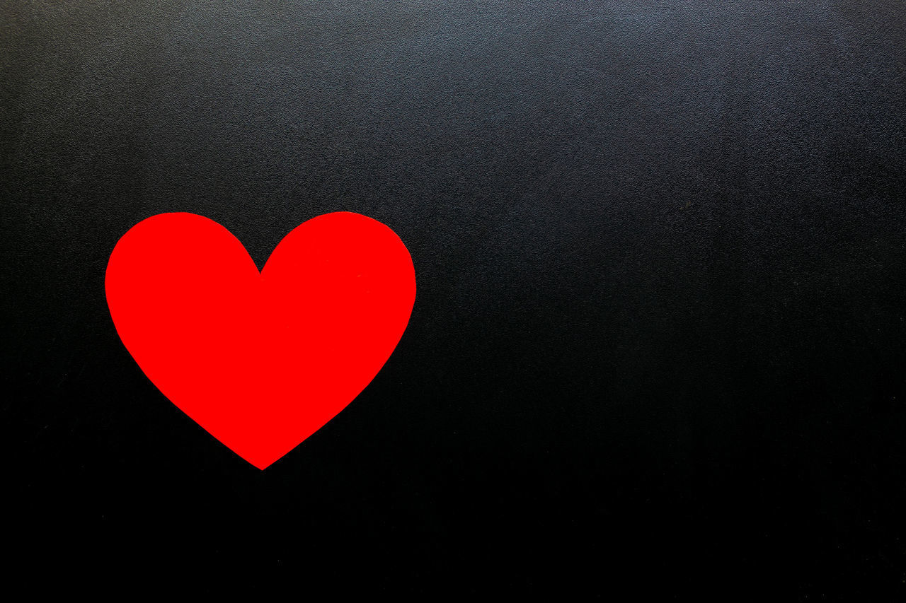 CLOSE-UP OF HEART SHAPE AGAINST BLACK BACKGROUND