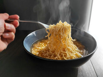 Close-up of person preparing food in bowl