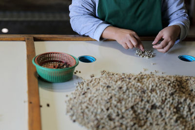 Midsection of man preparing food on table