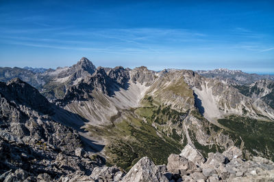 Scenic view of mountains against blue sky