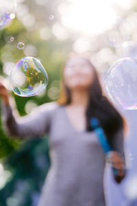 Low section of man holding bubbles