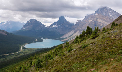 Scenic view of mountains against cloudy sky