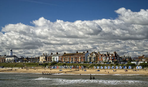 Buildings in city against cloudy sky