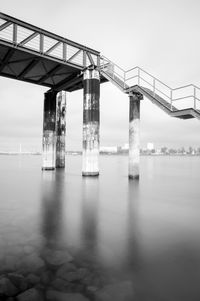 Bridge over sea against clear sky