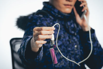 Midsection of man using mobile phone