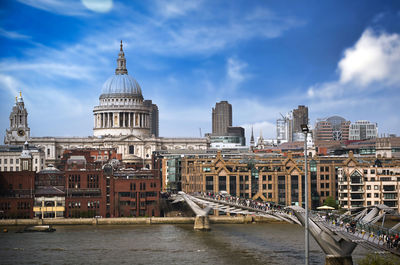 Bridge over river with buildings in background