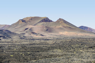 Scenic view of arid landscape against clear sky