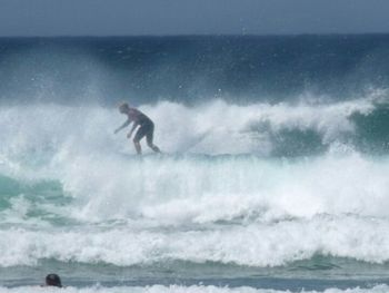 People surfing in sea