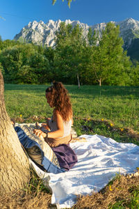 Woman sitting on grassland