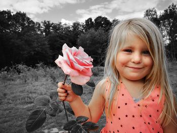 Portrait of smiling girl holding plant