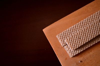 High angle view of paper on table against black background