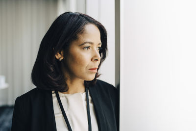 Close-up of businesswoman looking away at workplace