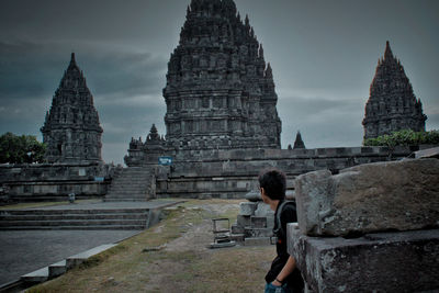 Woman visiting temple against building