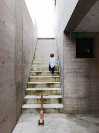 Rear view of man walking on corridor