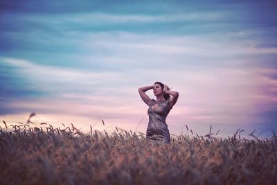 Full length of woman on field against sky during sunset