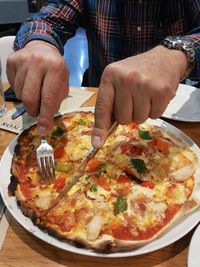 Close-up of hand with pizza