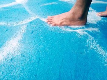 Midsection of person swimming in pool