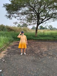 Full length of woman standing on field