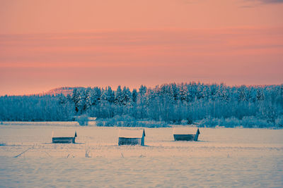 Scenic view of field against sky during winter