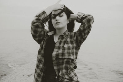 Front view of beautiful woman with tousled hair at beach