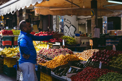 Full length of man standing at market stall