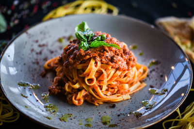 Tasty spaghetti bolognese with fresh basil