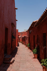 Street amidst buildings against clear sky