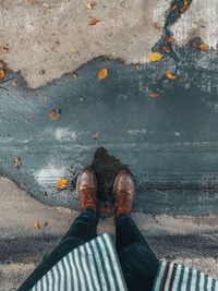 Low section of man standing on street