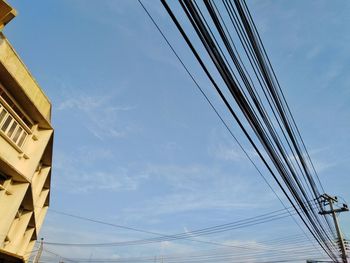 Low angle view of cables against sky