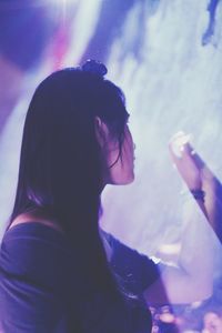 Side view of woman looking away during concert