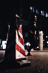 Person on illuminated street at night