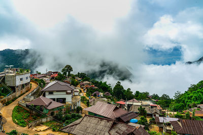 High angle view of houses and buildings against sky